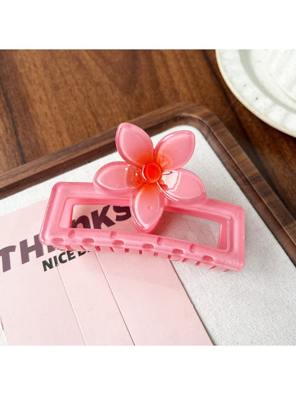 Beau square ombre flower shaped claw clip placed on wooden surface showing top floral design