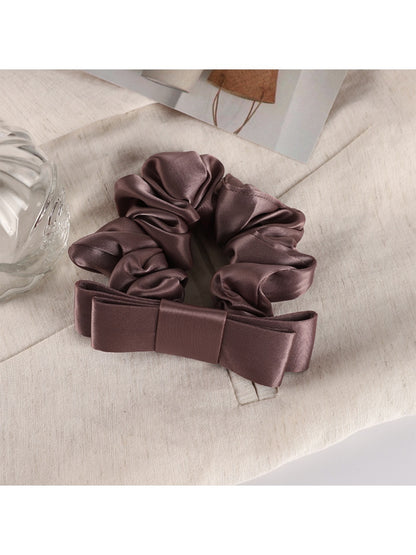 Scrunchie laid flat showing full circular shape and pastel floral print