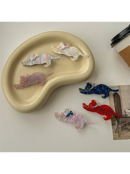 Beau cat shaped hair clip held in hand showing size and shape