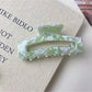 Beau claw clip shown from above emphasizing large square cutout and matte texture