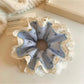 Flat lay of multiple Gifty bow print ruffled scrunchies in different pastel shades