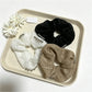 Close-up of Gifty sweet cute lace scrunchie in soft pastel color on white background