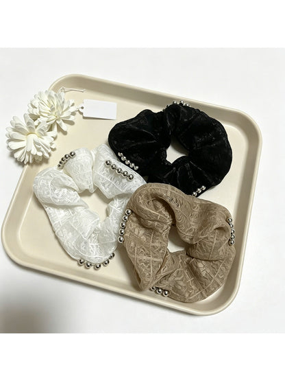 Close-up of Gifty sweet cute lace scrunchie in soft pastel color on white background