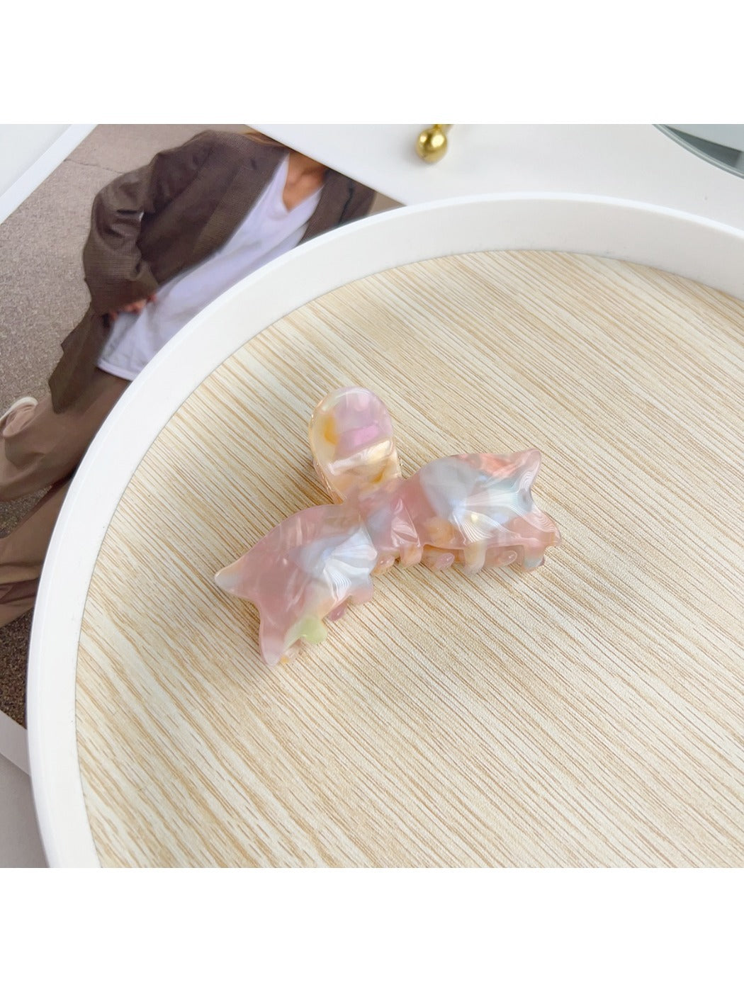 Model adjusting Beau sweet bow shaped hair claw clip in hair