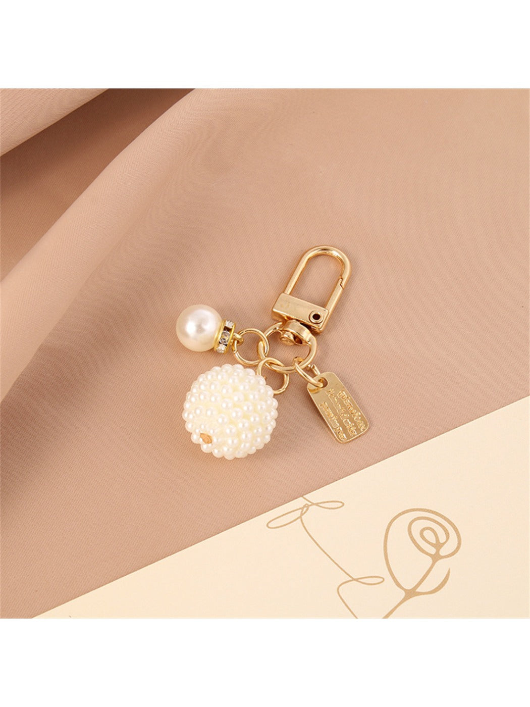 Side view of the round ball and heart keychain highlighting the smooth metal surface