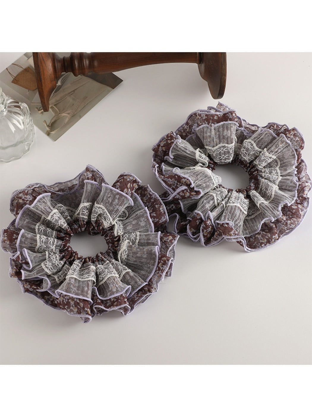 Close-up of vintage purple floral scrunchie fabric with detailed flower pattern