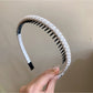 Gifty headband laid flat to show its full length and shape
