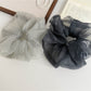 Soft breathable tulle scrunchie with white polka dots on light pink fabric