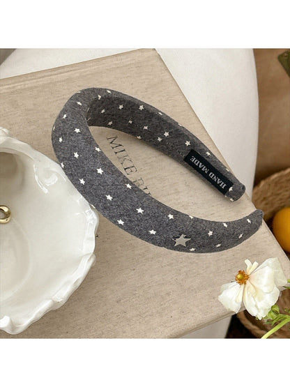 Solid color star hairband displayed on a flat surface with natural lighting