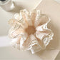Gifty Sweet Bow Print Ruffled Scrunchie worn on a wrist showcasing its size and pattern