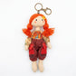 Fabric yarn doll keychain photographed on a plain background for product display