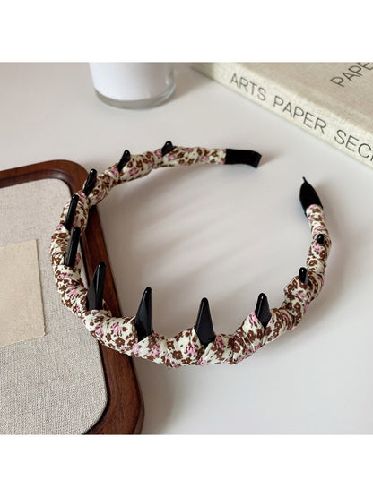 Top view of twisted knot floral headband highlighting fabric texture