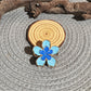 Beau lively sunny flower hair clip held in hand showing size and texture