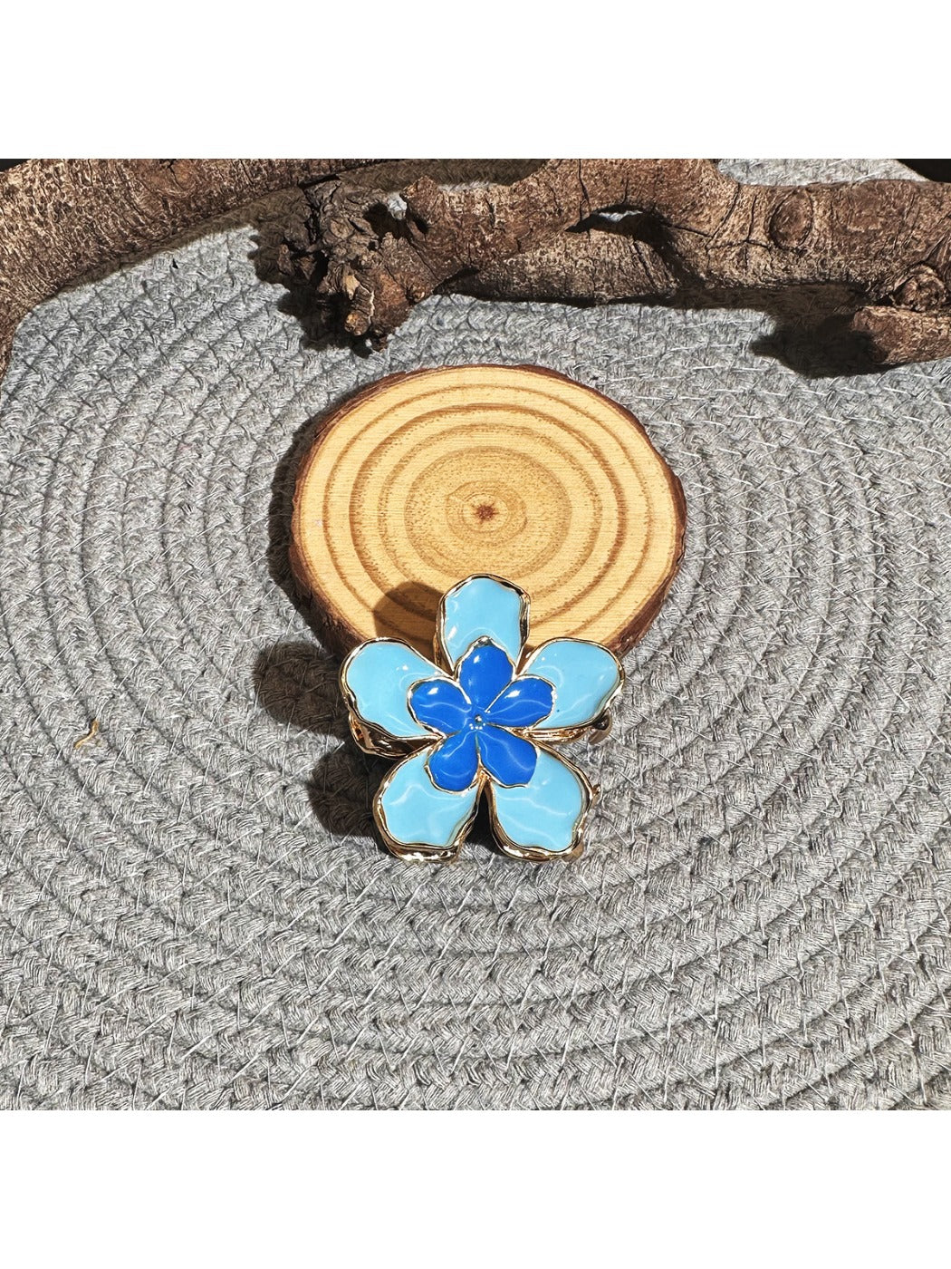 Beau lively sunny flower hair clip held in hand showing size and texture
