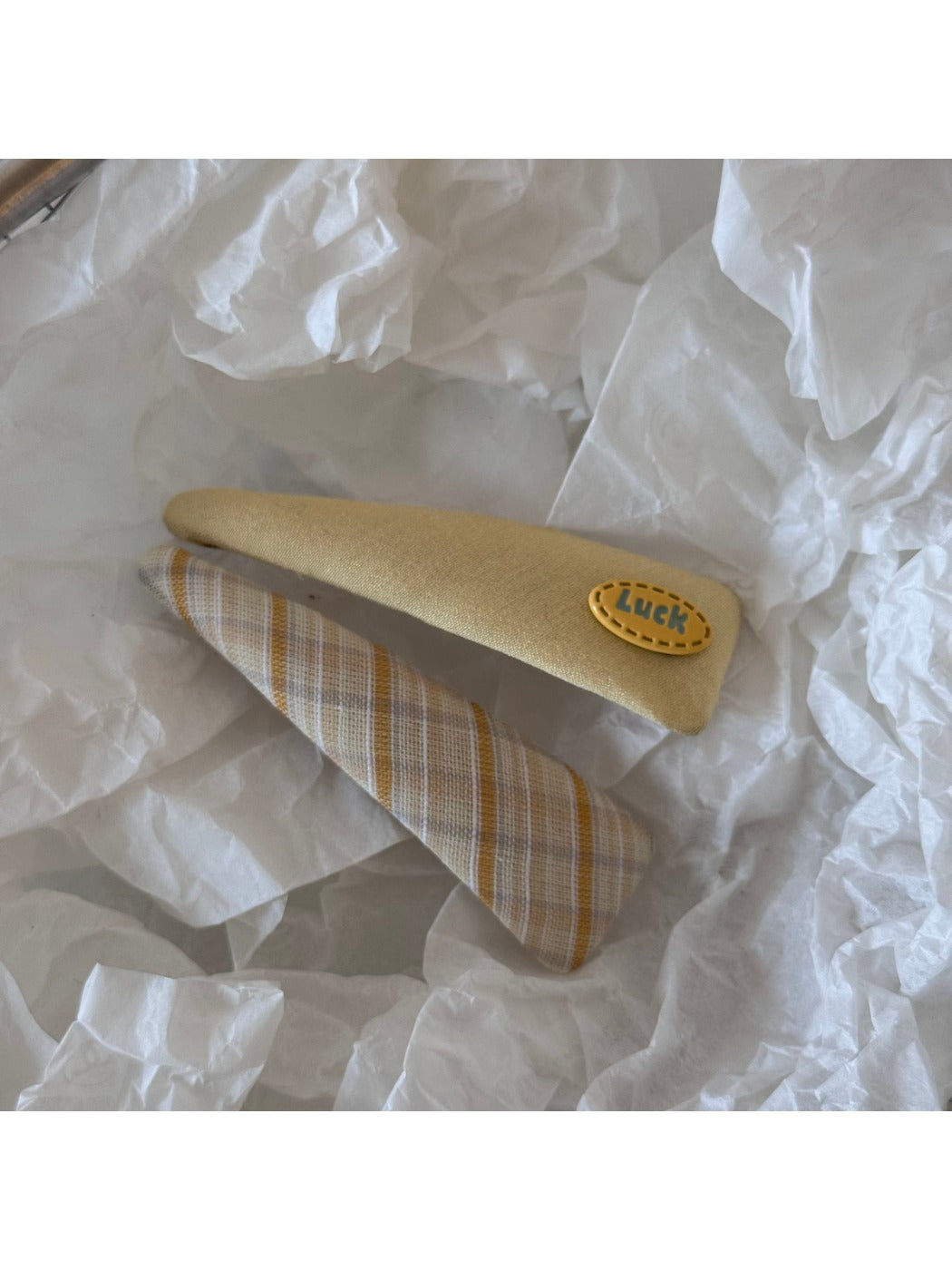 Beau oval hair clip held in hand displaying size and colorful resin details
