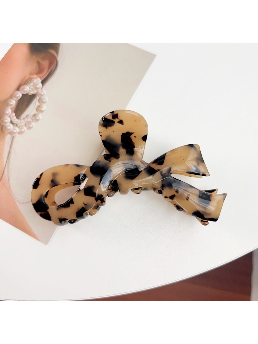 Beau bow hair claw clip next to matching hair accessories on white background