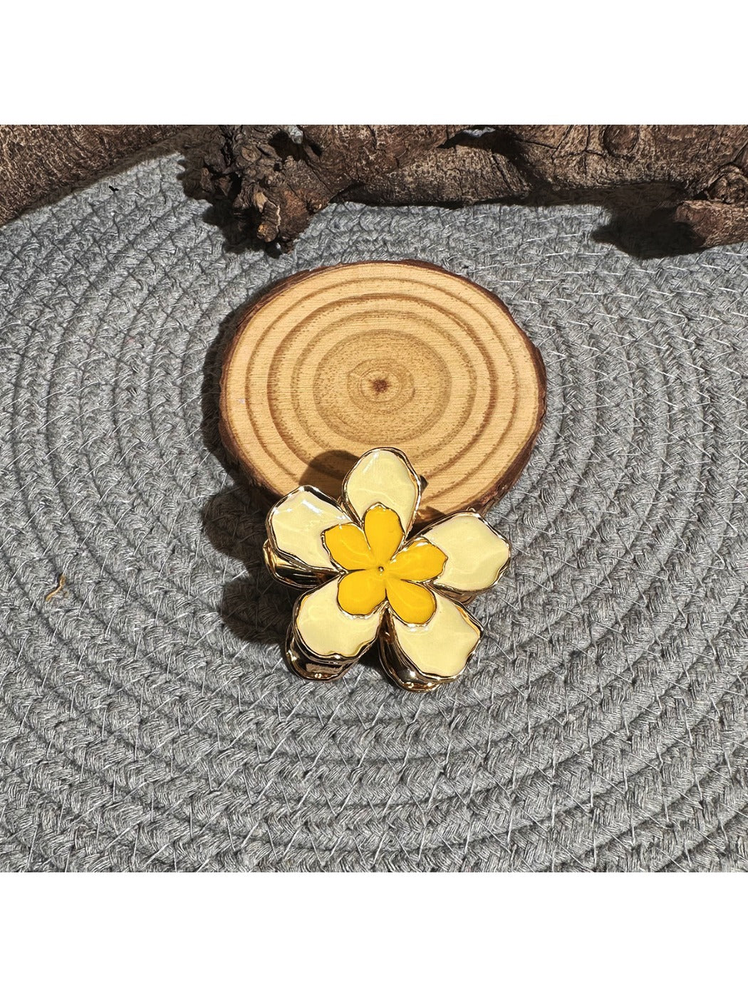 Beau lively sunny flower hair clip displayed on a white background