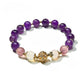 Lovra vintage purple beaded bracelet arranged in a circular shape on a flat surface