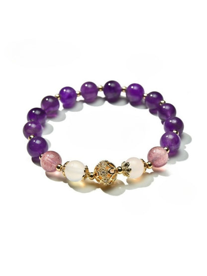 Lovra vintage purple beaded bracelet arranged in a circular shape on a flat surface
