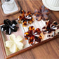 Side view of Beau flower shaped claw clip with leopard pattern