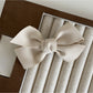 Beau satin bow hair clip photographed with soft natural lighting