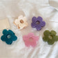 Beau minimalist mini flower shaped claw clip in beige on white background