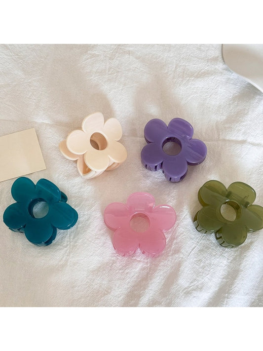 Beau minimalist mini flower shaped claw clip in beige on white background