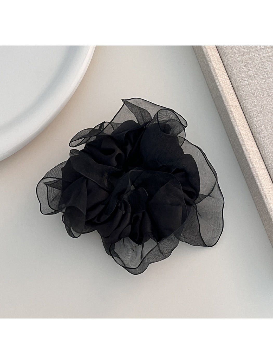 Solid color ruffled scrunchie displayed flat to highlight its shape and ruffles