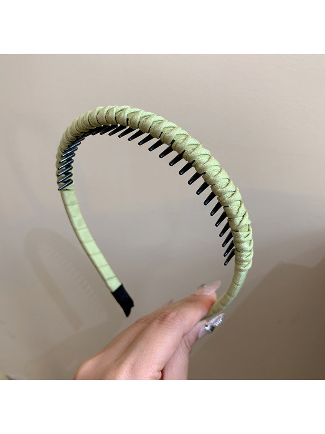 Model adjusting Gifty minimalist headband in front of a mirror