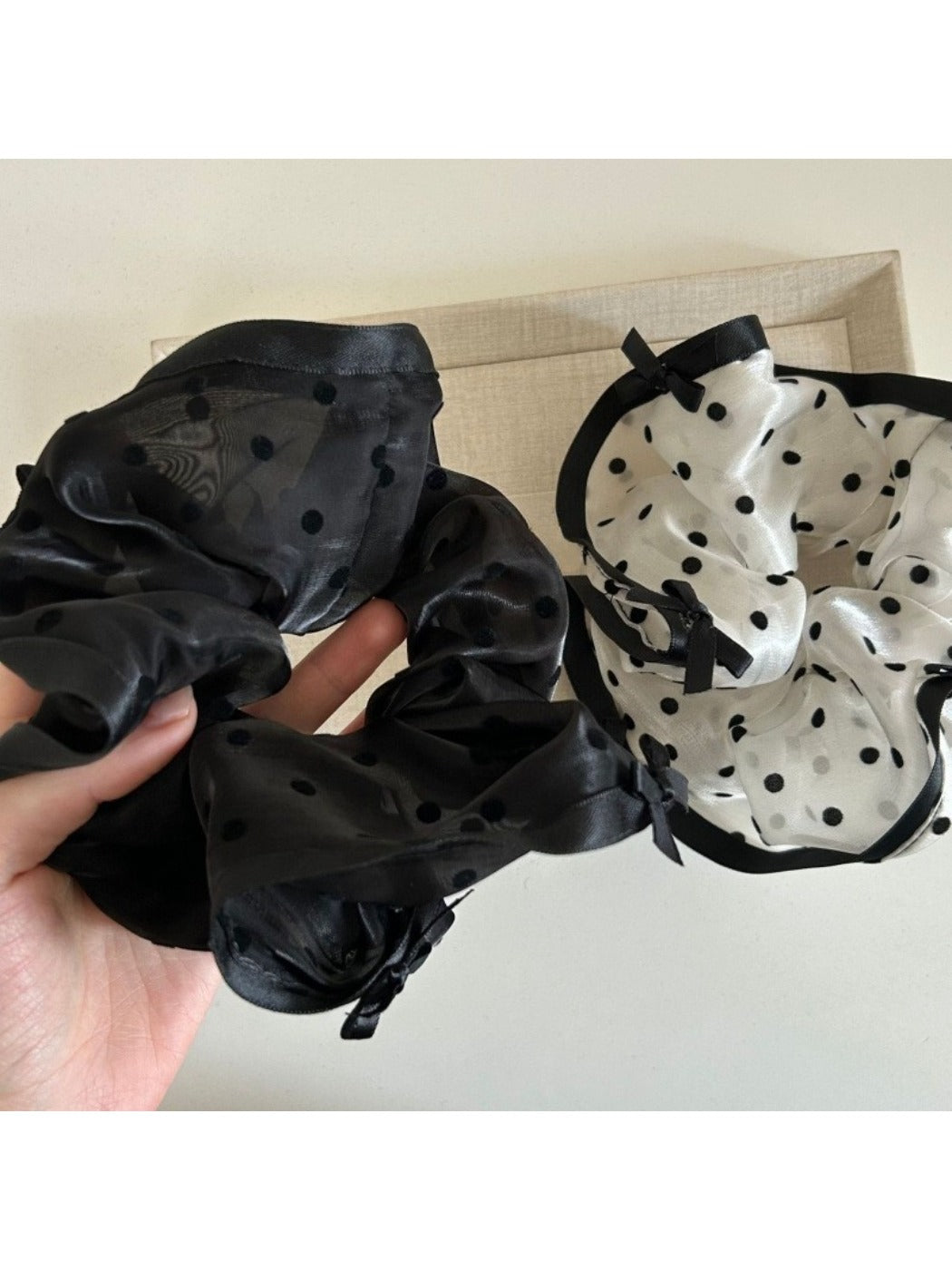 Gifty bow tulle scrunchie displayed on a wooden surface showing texture and bow detail