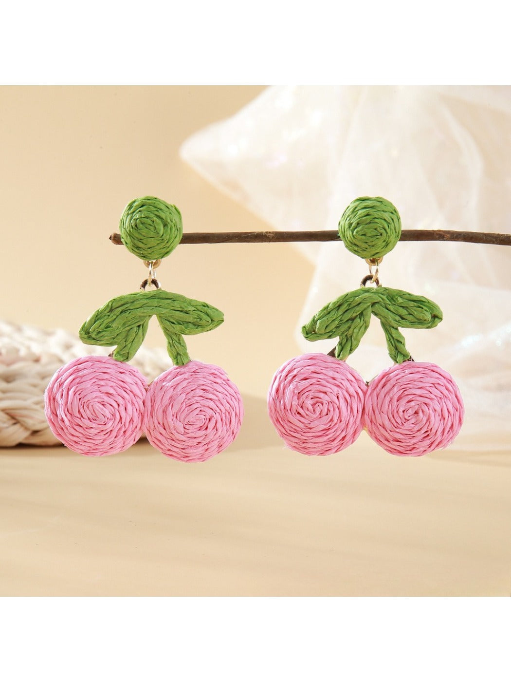 Close-up of earring hooks attached to raffia cherry shaped earrings