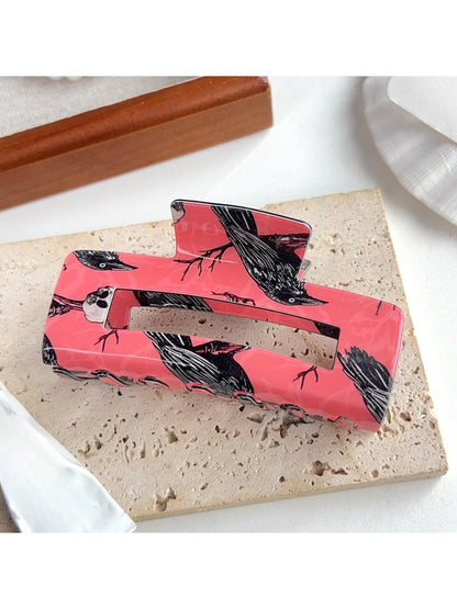 Beau hair claw clip with crow design, viewed from top angle