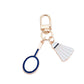 Badminton shuttlecock keychain hanging from a set of keys with a blurred background