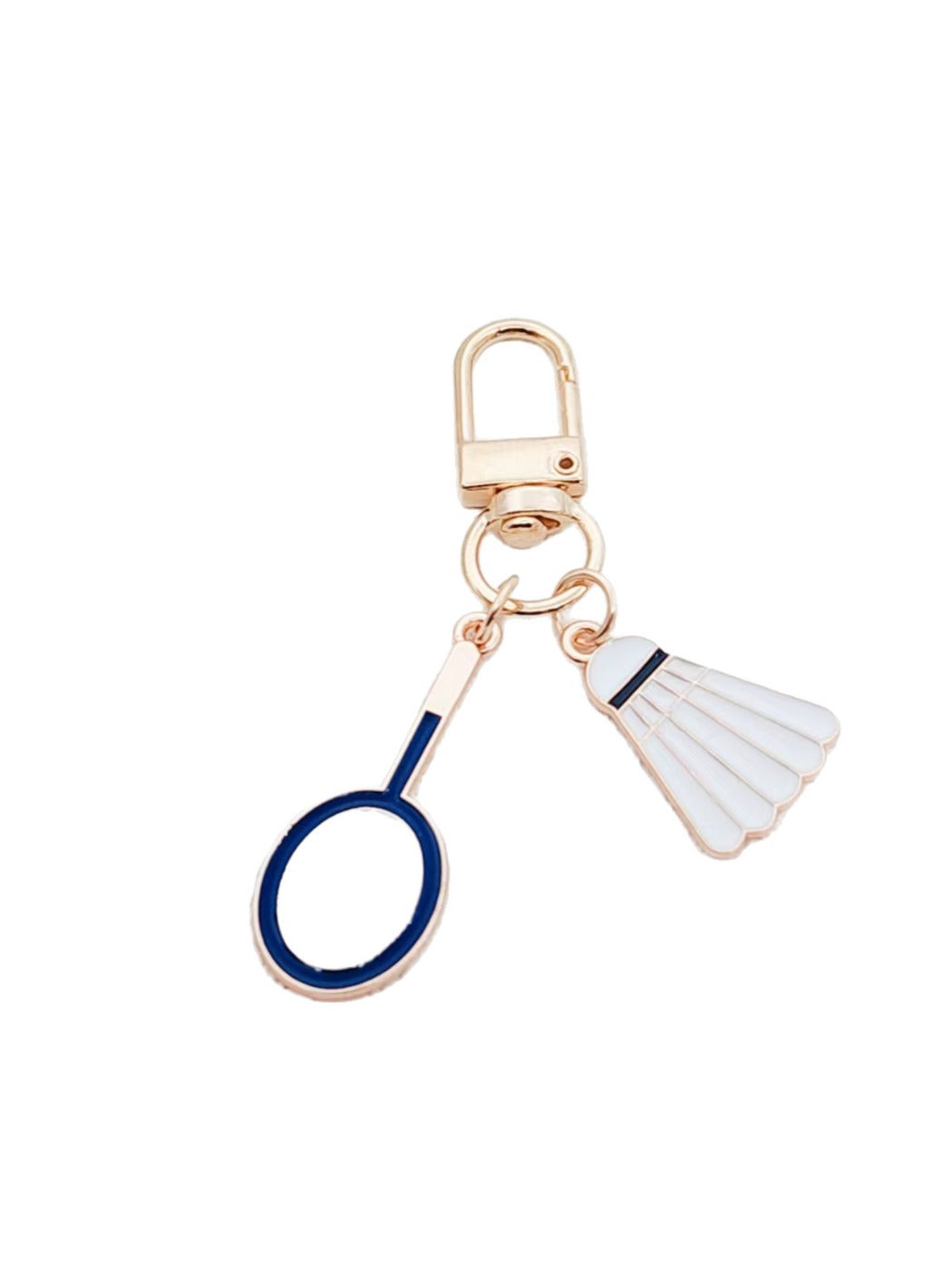 Badminton shuttlecock keychain hanging from a set of keys with a blurred background