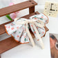 Beau Chic Sweet Bow Hair Clip packaged in branded box with clear window
