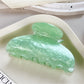 Beau crescent shaped claw clip photographed with soft natural lighting