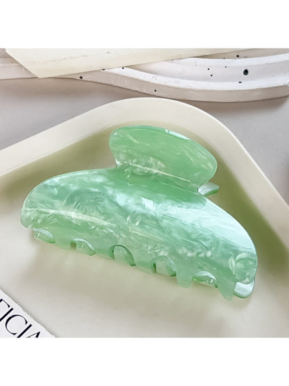 Beau crescent shaped claw clip photographed with soft natural lighting