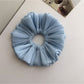 Top view of Gifty double layer shimmer scrunchie highlighting fabric layers