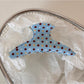 Beau blue hair clip styled in blonde hair