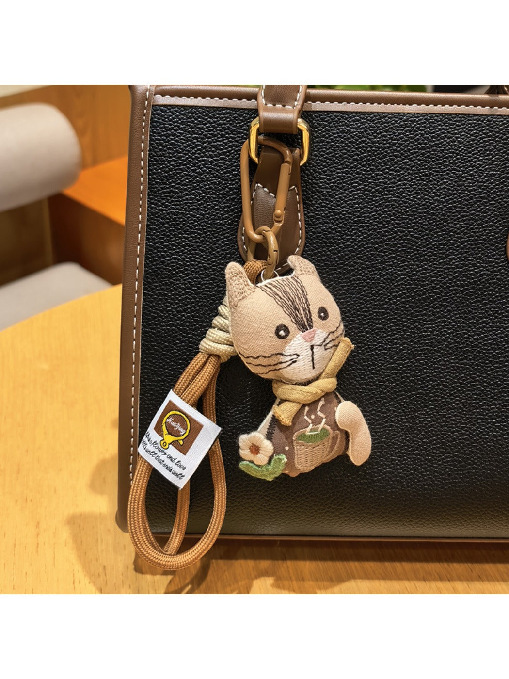 Detailed engraving on vintage cat charm keychain with floral patterns