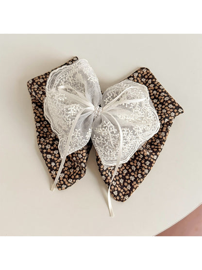 Beau floral lace bow claw clip holding hair in place