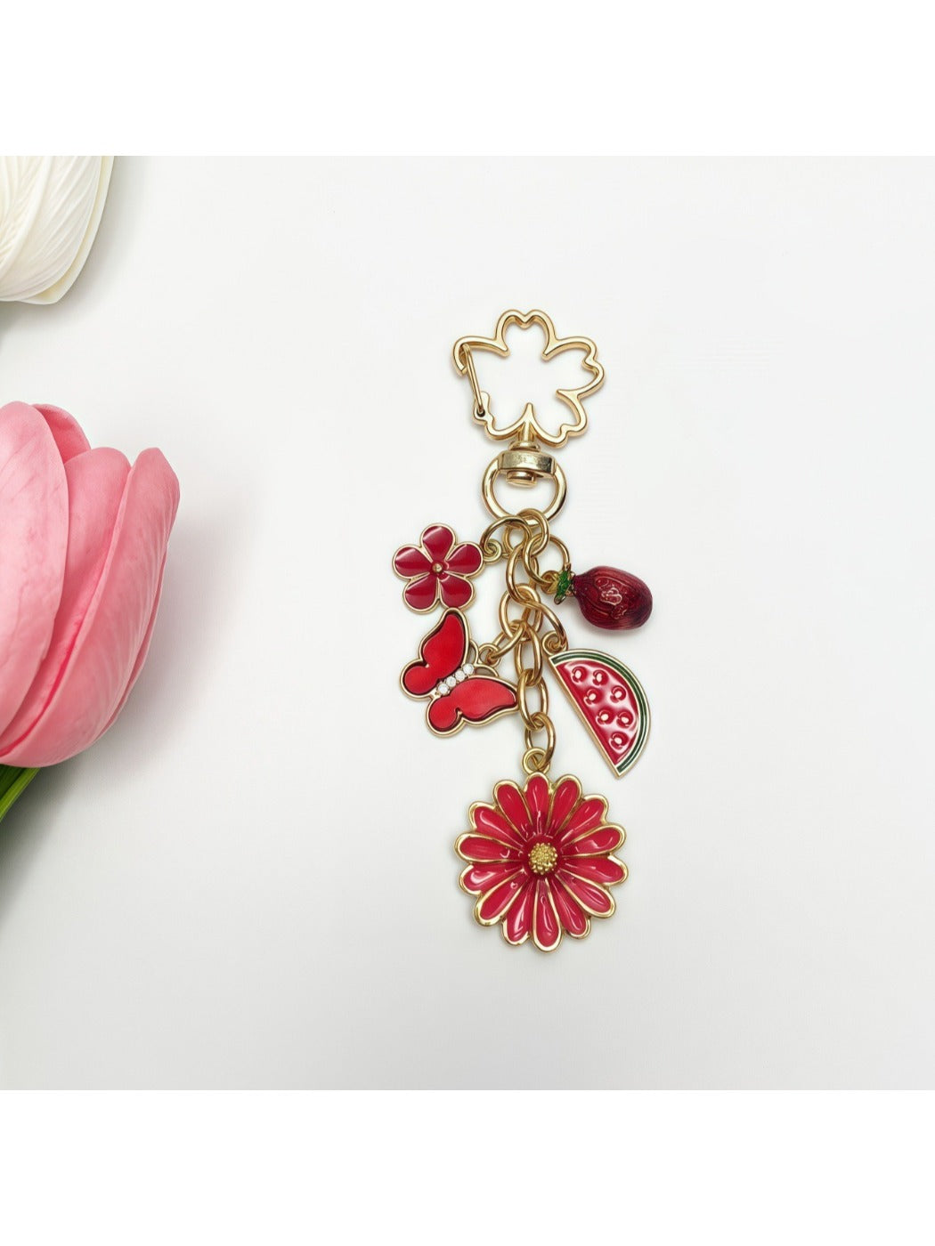 Detailed shot of the daisy charm showing petal and center design on gold keychain