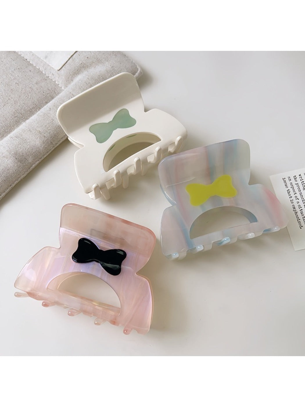 Beau hair claw clip held in hand highlighting size and lightweight design