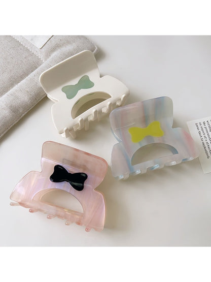 Beau hair claw clip held in hand highlighting size and lightweight design