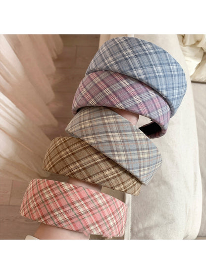 Close-up of the plaid pattern on the wide headband showing fabric texture