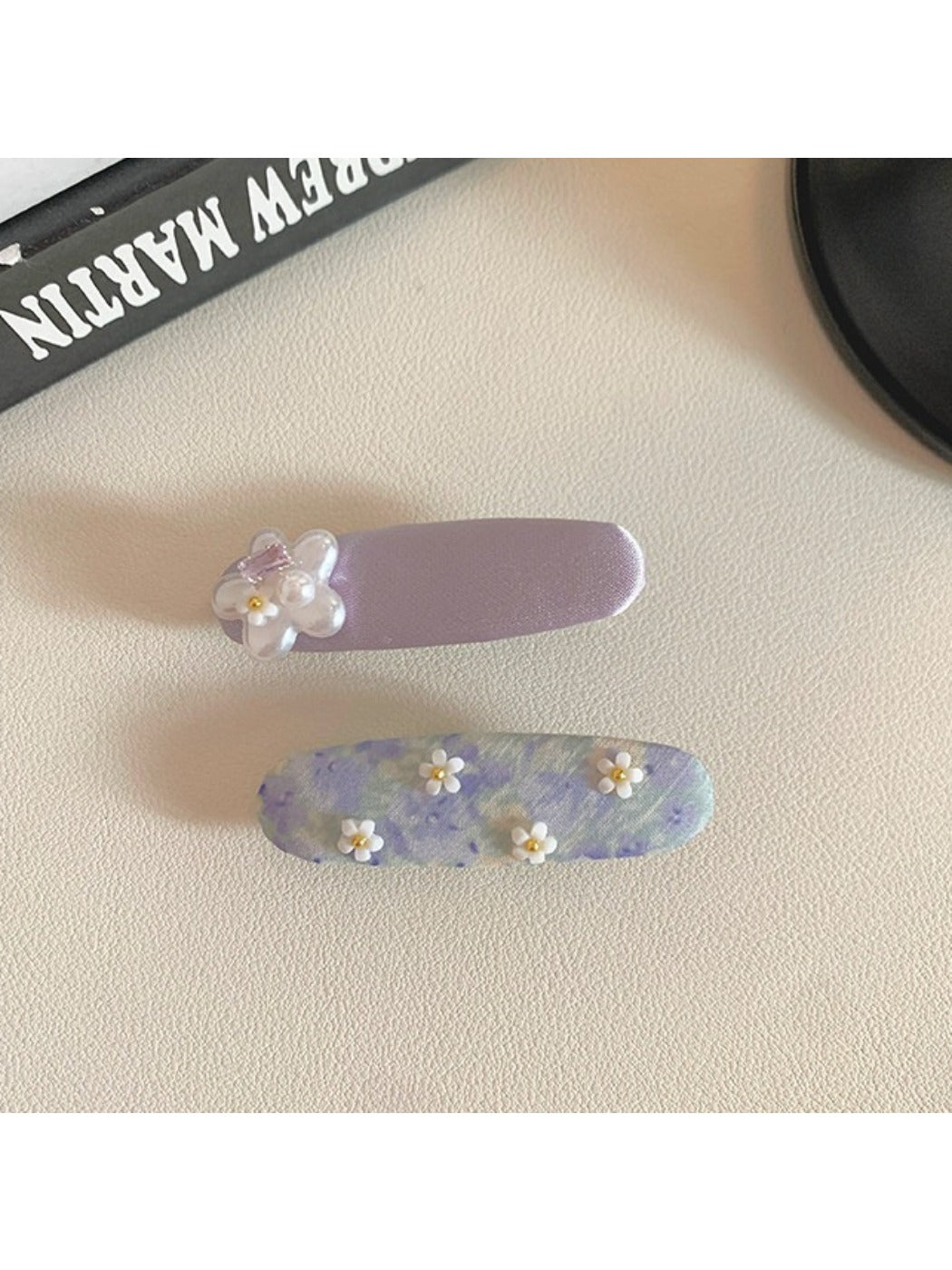 Beau sweet purple flower hair clip displayed on a white surface