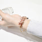 Side view of Lovra crystal charm bracelet with silver chain links