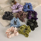 Soft romantic charm scrunchie in pastel pink fabric with delicate floral pattern