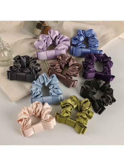 Soft romantic charm scrunchie in pastel pink fabric with delicate floral pattern