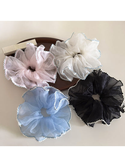 Close-up of Gifty elegant solid color ruffled scrunchie in soft fabric